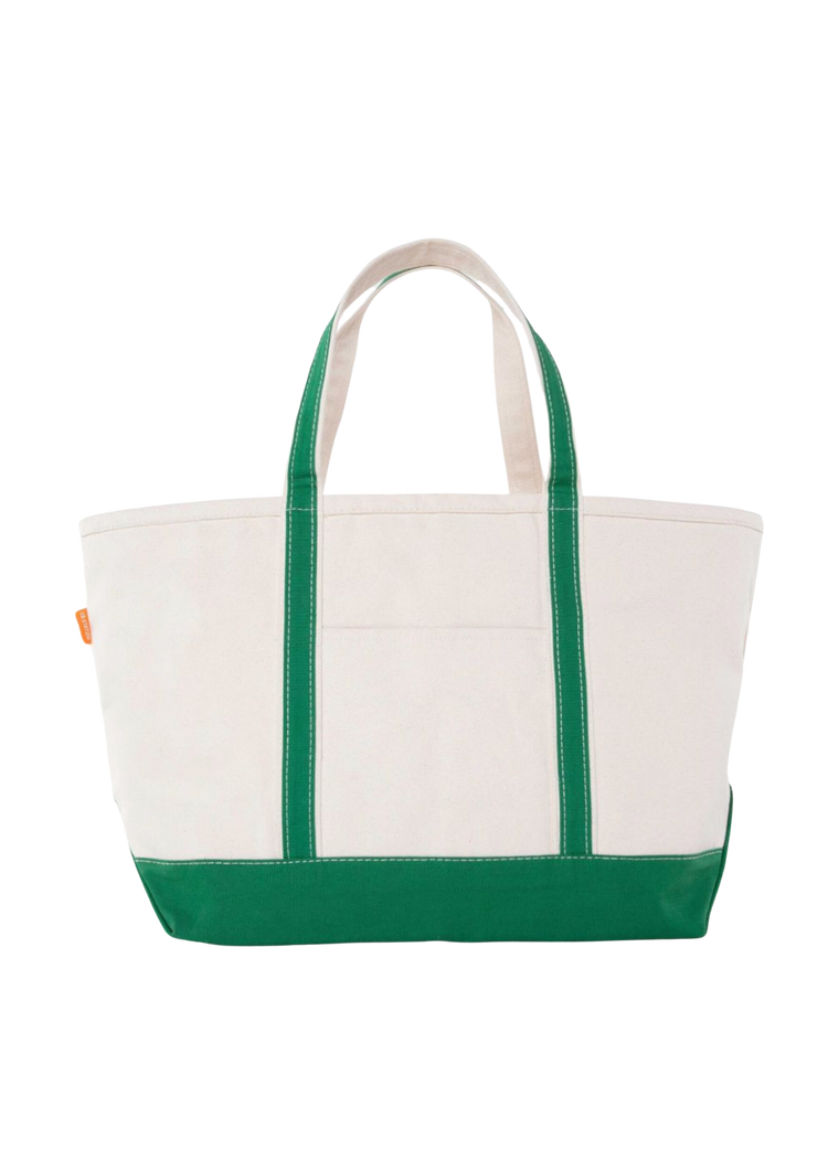 A canvas boat tote with a navy blue base and white upper part, featuring two handles and a front exterior pocket.