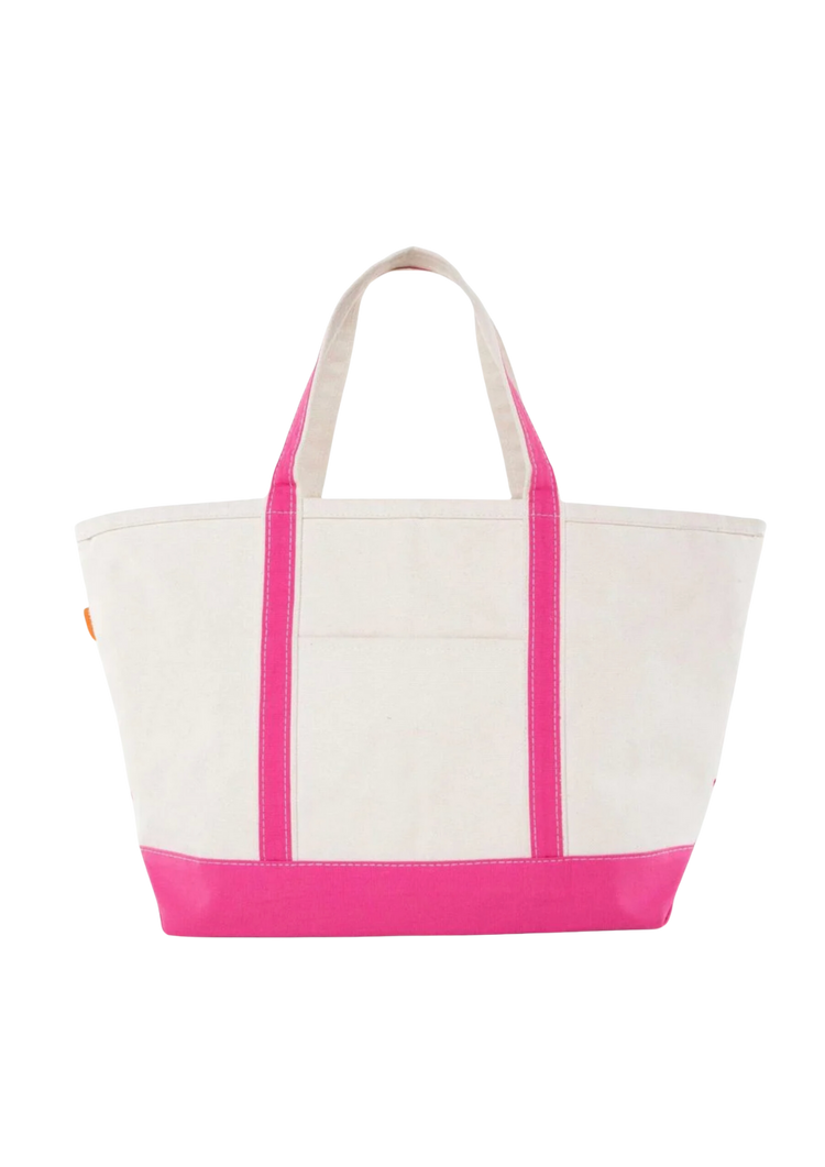 A canvas boat tote with a navy blue base and white upper part, featuring two handles and a front exterior pocket.