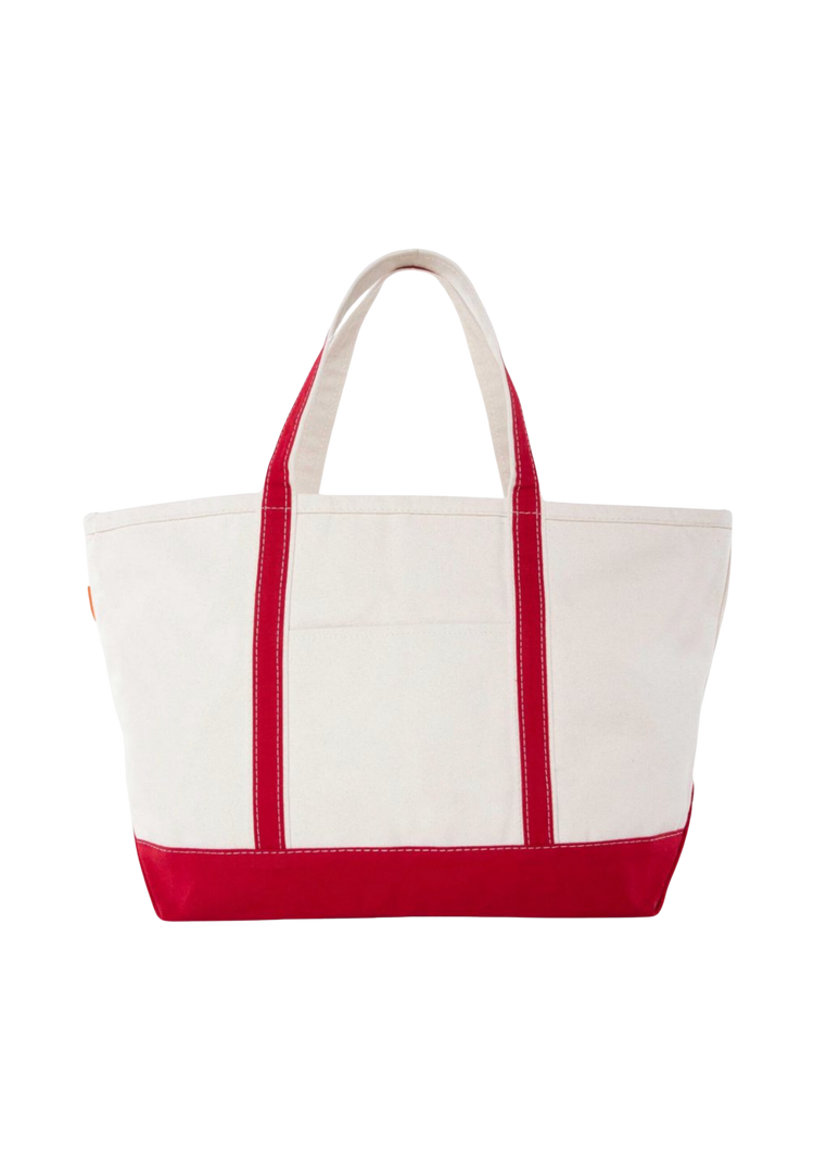A canvas boat tote with a navy blue base and white upper part, featuring two handles and a front exterior pocket.