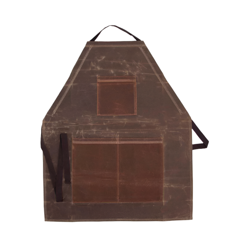 A brown waxed canvas apron with front pockets and an adjustable neck strap, displayed against a plain background.