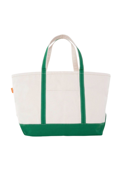A canvas boat tote with a navy blue base and white upper part, featuring two handles and a front exterior pocket.
