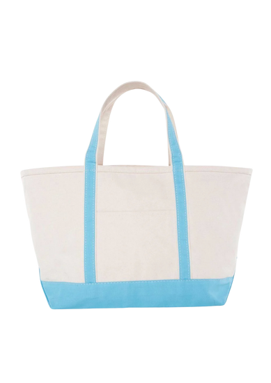A canvas boat tote with a navy blue base and white upper part, featuring two handles and a front exterior pocket.