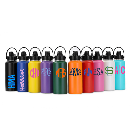 A row of ten reusable water bottles with black lids and carrying loops, shown in multiple colors including black, blue, yellow, purple, green, orange, red, pink, white, and turquoise. Each bottle has a different colorful monogram design on the front, set against a plain white background.