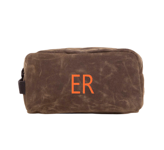 Waxed Canvas toiletry bag with 'ER' initials on a white background