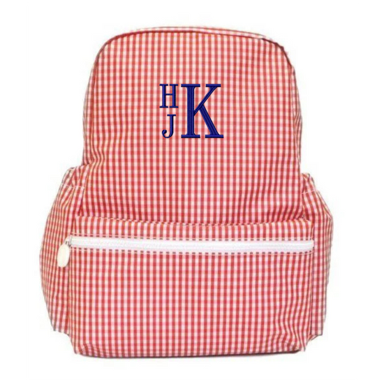 Red and white checkered backpack with blue monogram on a white background