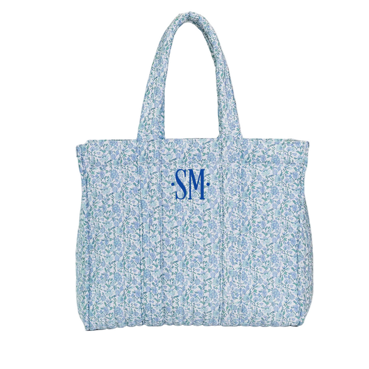 Floral patterned tote bag with 'SM' monogram on a white background